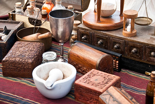 Alchemist desk Lot of ancient alchemist instruments, boxes and bottles over a table alchemy photos stock pictures, royalty-free photos & images