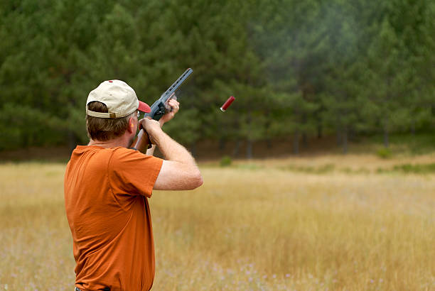 Unrecognizable man shoots with a black powder revolver