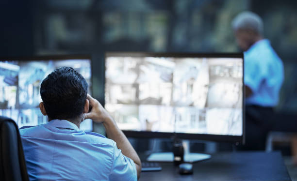 istock Security guard in control room, man checking cctv screen in surveillance office for building safety. Inspection, technology and video stream to monitor crime, privacy and night protection service. 1575585064