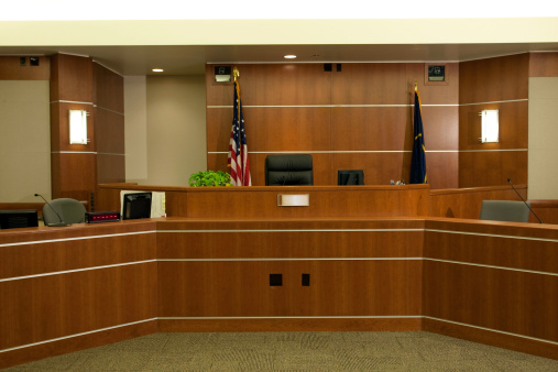 Royalty free image showing a the judge's bench in a modern courtroom setting. 