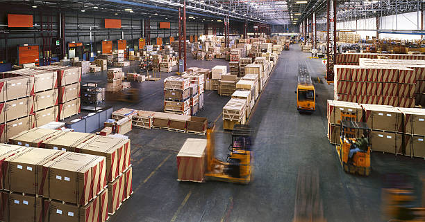 View from above inside a busy huge industrial warehouse Indoor manufacturing and storage detail distribution warehouse stock pictures, royalty-free photos & images