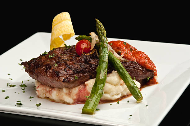 Sirloin steak with mashed potatoes and asparagus Sirloin steak with mashed potatoes and asparagus on black background main course stock pictures, royalty-free photos & images