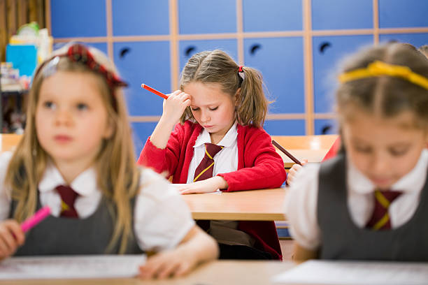 istock Little Girl Struggling With School Work 157558704