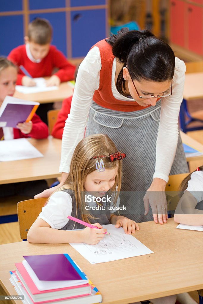Elementary School Children Teacher Helping  6-7 Years Stock Photo