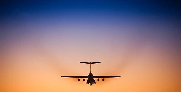 istock Jet airplane landing in beautiful sunset sky 157559113