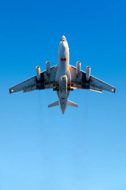istock Heavy airplane flying in blue sky. Slight motion blur 157559114