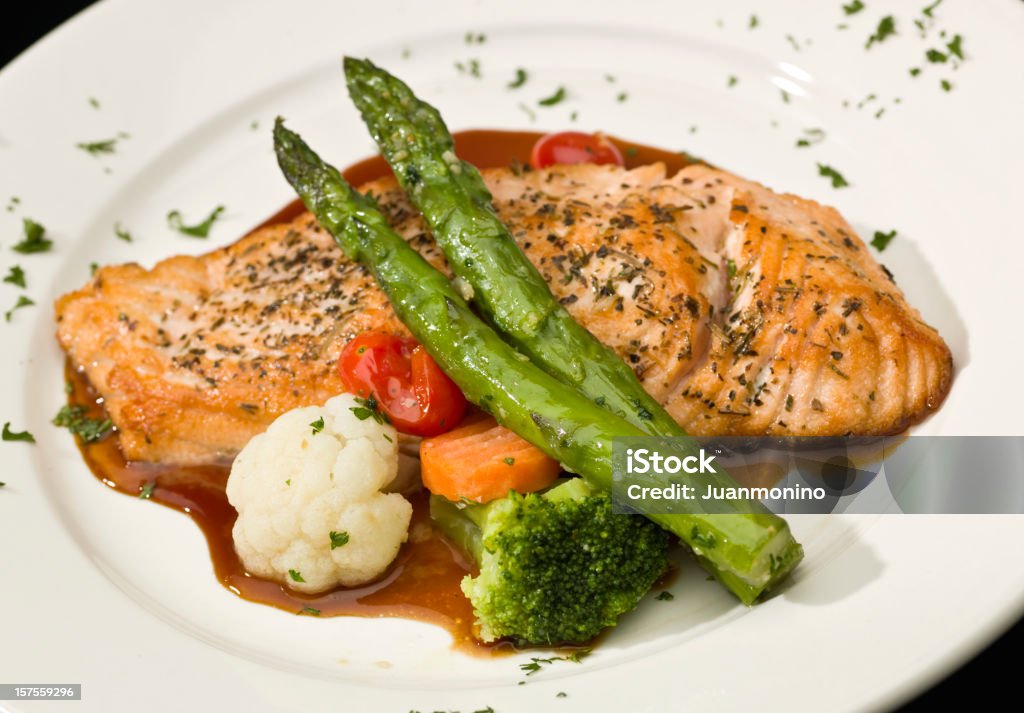 Salmón adobado en salsa de hierbas - Foto de stock de Al horno libre de derechos