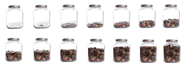 Saving Your Coins Series of Jar Filling 14 photographs of the same jar at different stages of full; sequence from empty to full of US coins jar stock pictures, royalty-free photos & images