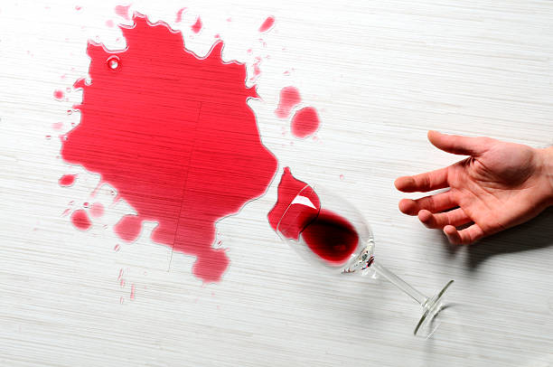 Close-up of spilled red wine on the white floor, studio Close-up of spilled red wine on the white floor, studio shot. wine glass knocked over stock pictures, royalty-free photos & images