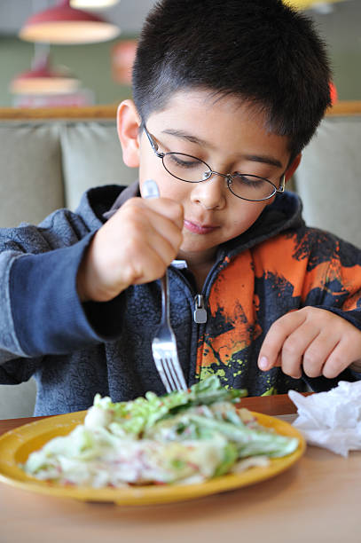 istock Little boy eating healthy - salad 157559710