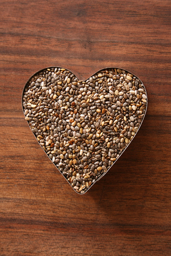 Coffee beans are laid out in the shape of a heart. Isolation on a white background.