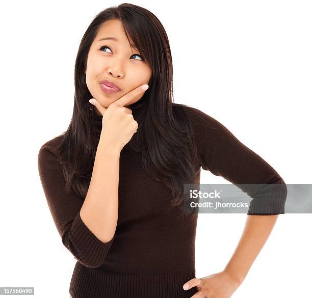 Contemplative Young Asian Woman Stock Photo - Download Image Now - White Background, Contemplation, Confusion
