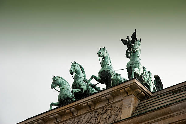 Brandenburg Gate illuminated at twilight - The iconic Brandenburg Gate in Berlin, a symbol of peace and unity, beautifully illuminated against the twilight sky at Pariser Platz, Germany.