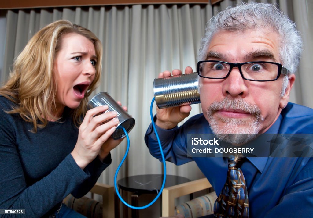 Communication Woman yelling into tin can phone Humor Stock Photo