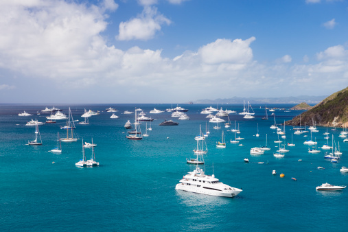 view of luxury yachts at anchor in the Caribbean harbor