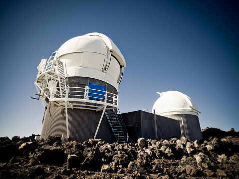 Space Observatory on the top of the Mount Haleakala Volcano. At 10,000 feet elevation above sea level, Haleakala Observatory is above one third of the earth's atmosphere. Maui, Hawaii, USA. Edited desaturated colors.