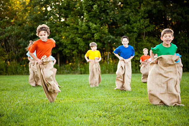 istock Happy Children Having a Fun Potato Sack Race Outside 157561248