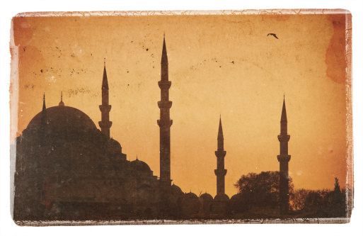 postcard composite with old papers and a picture of the yeni cami mosque (new mosque of Istanbul) at dusk