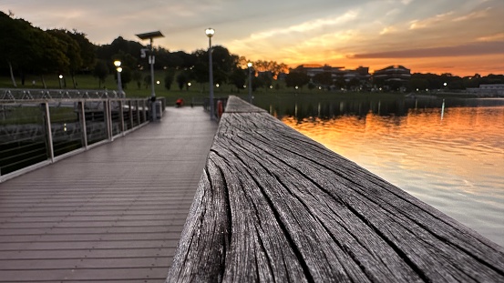 Golden hour sunset outdoor park pedestrian bridge evening walk near reservoir and hill
