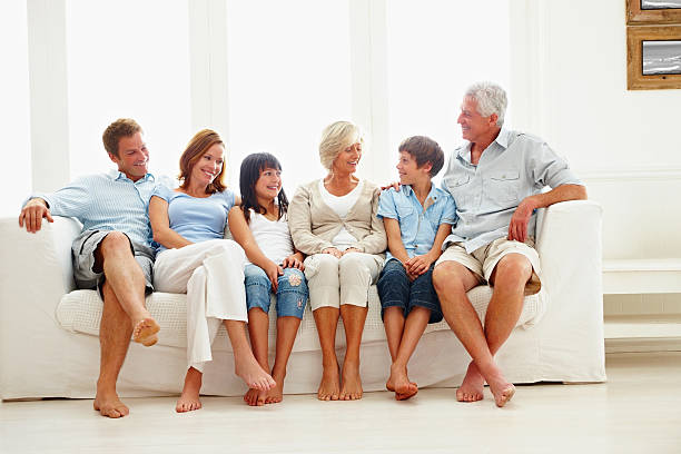 istock Happy three generational family sitting together on a couch 157561780