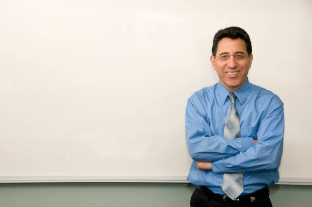 College Professor Standing in Front of a White Board stock photo