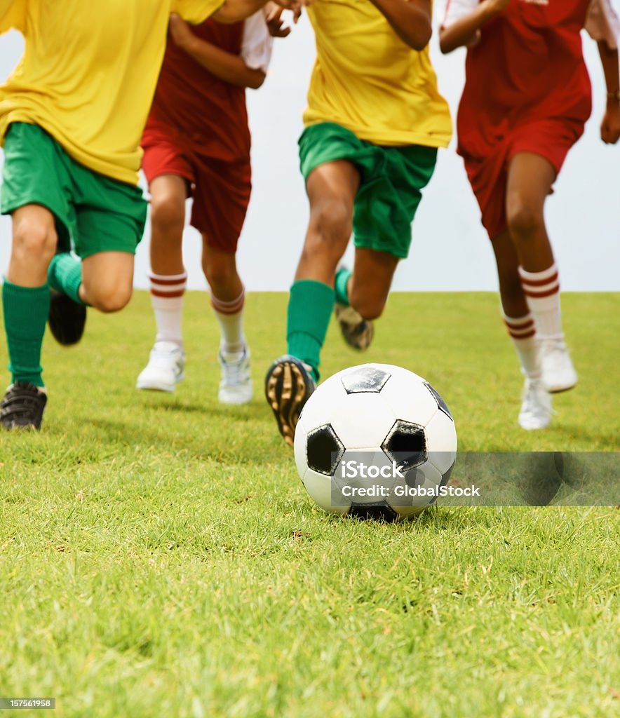 Group of children playing football in a stadium  10-11 Years Stock Photo