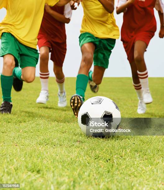Group Of Children Playing Football In A Stadium Stock Photo - Download Image Now - 10-11 Years, 8-9 Years, Boys