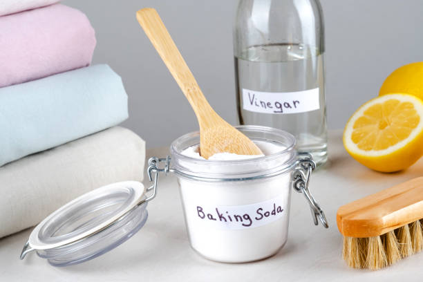 Eco friendly natural cleaners baking soda, vinegar, lemon and clothing on a white table Eco friendly natural cleaners baking soda, vinegar, lemon and clothing on a white table. isolated. Clothing green cleaning alternatives stains club soda stock pictures, royalty-free photos & images