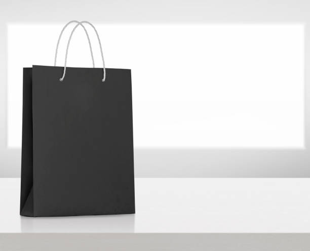 istock black paper bag on white wooden table 1575623194
