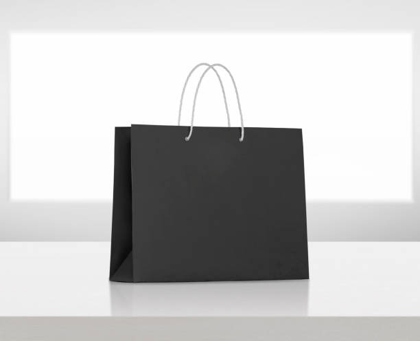 istock black paper bag on white wooden table 1575623195