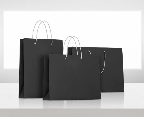 istock black paper bag on white wooden table 1575623196