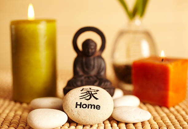 Spa still life buddha statue and candles, home pebble Spa still life Buddha statue and river rock, bamboo in vase, and candles, and home river rock in Japanese characters feng shui photos stock pictures, royalty-free photos & images