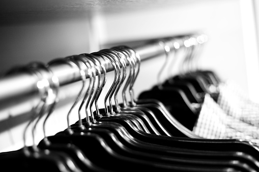 black and white close up of of any clothes on hanger, foukus is in the middle