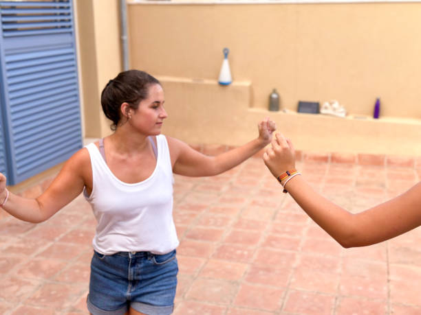istock Two young girls taking dance lessons online in the backyard 1575632142