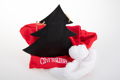Christmas tree made black slate and santa claus hat on white background New Year background