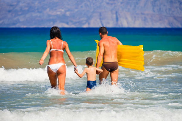 Happy family having fun in sea. http://santoriniphoto.com/Template-Greek.jpg