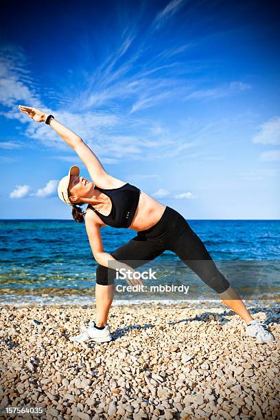 Adulto Joven Mujer Haciendo Ejercicio De Yoga En La Playa En La Mañana Foto de stock y más banco de imágenes de Actividad