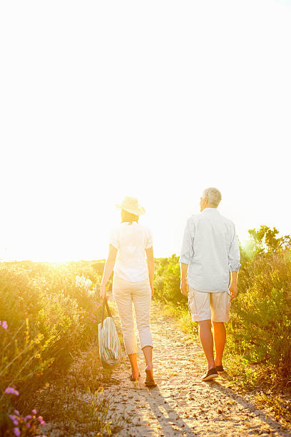 istock Couple walking on a dirt road during sunset 157564264