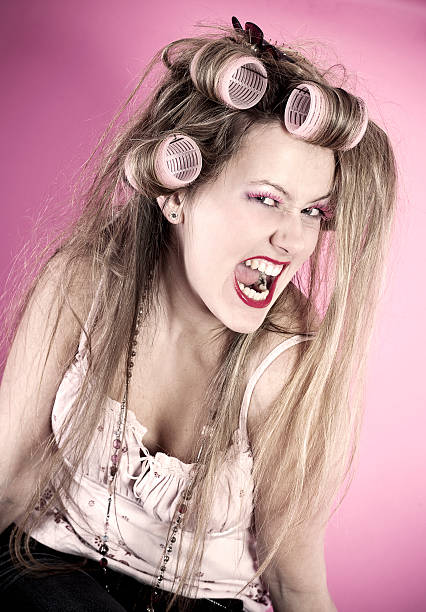istock Young angry woman with curlers 157564296