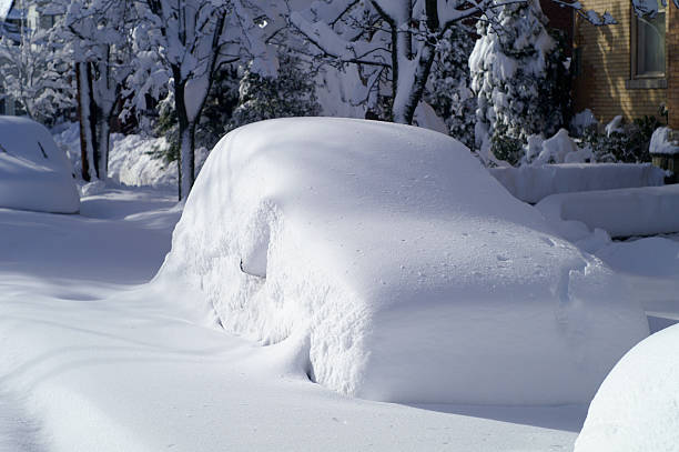 Car after Snow Storm Car on city street after large snowfall. deep snow stock pictures, royalty-free photos & images