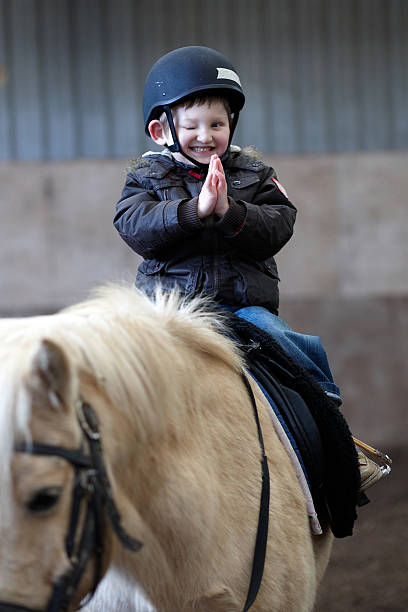 Bold man riding on a grey horse.