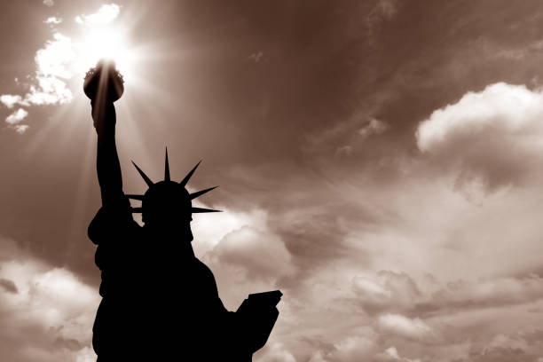 istock statue of liberty and sun beam 157564862