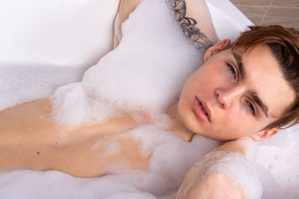 istock Relax and rest. Young attractive guy in the bath. 1575649756