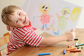 Boy with Down Syndrome shows his drawing