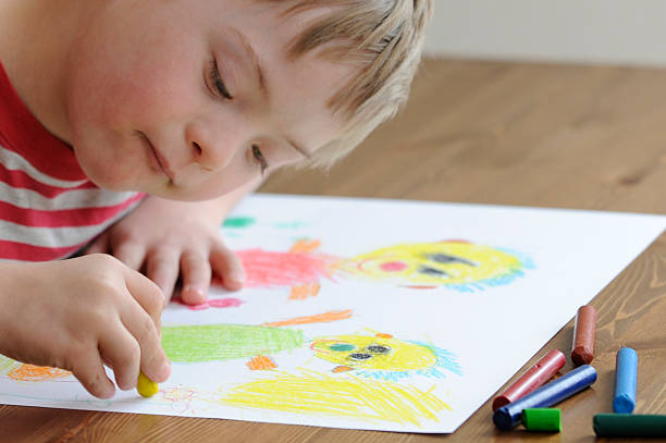 Seven year old boy with Down Syndrome is drawing. More photo's of this boy: