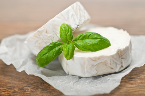 Goats Cheese on wooden background with shallow depth of field