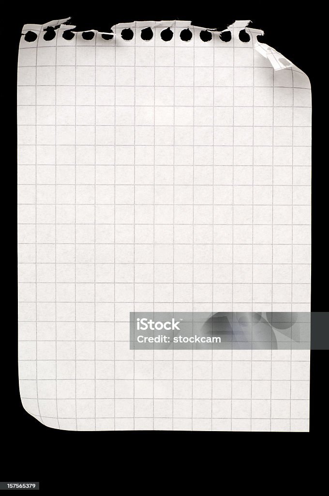 Blank sheet of maths paper on black A sheet of checked paper, isolated on a black background Cut Or Torn Paper Stock Photo