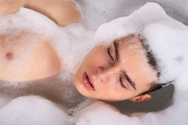 istock Relax and rest. Young attractive guy in the bath. 1575657123