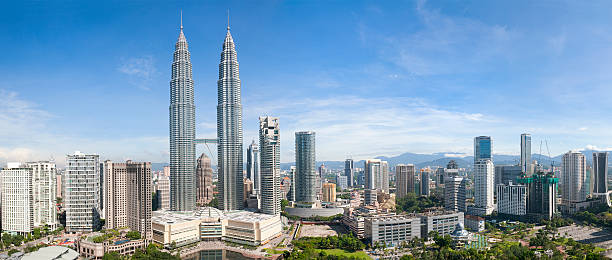 Kuala Lumpur Skyline Panorama A panoramic cityscape of the downtown area of Malaysia's capital city, Kuala Lumpur, including the Petronas Twin Towers and other skyscrapers. malaysia stock pictures, royalty-free photos & images