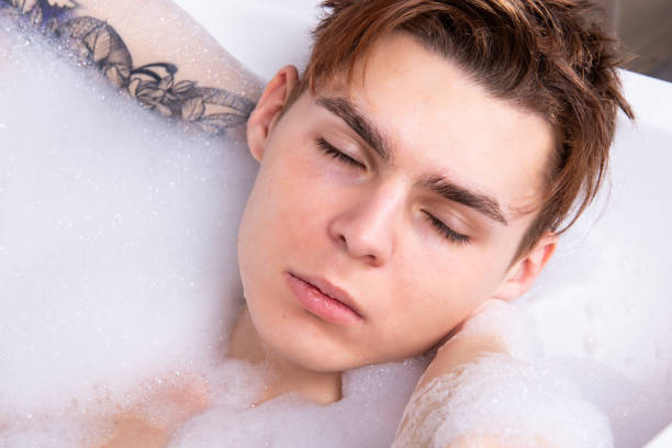 istock Relax and rest. Young attractive guy in the bath. 1575659354